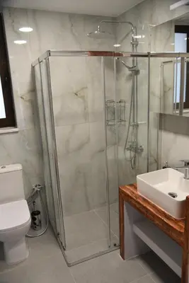 a bathroom with a shower and a toilet and a sink at Pirgos Deluxe Apartment - Private Parking in Kissamos