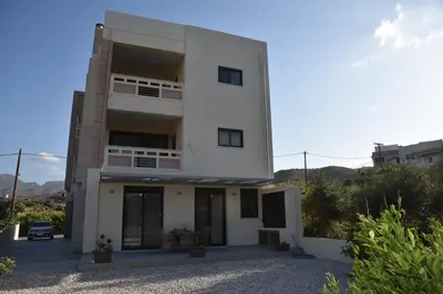 a large white house with a driveway at Pirgos Deluxe Apartment - Private Parking in Kissamos