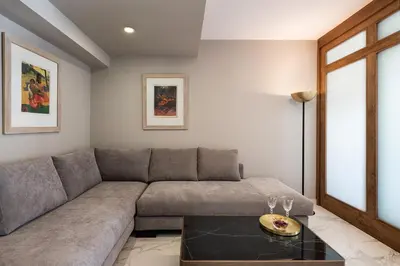 a living room with a couch and a table at Porto Platanias Beach Luxury Selection - Adults Only in Plataniás