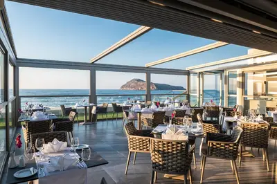 a restaurant with a view of the ocean at Porto Platanias Beach Luxury Selection - Adults Only in Plataniás