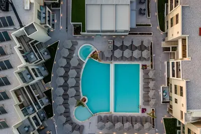 an overhead view of a swimming pool in a city at Porto Platanias Beach Luxury Selection - Adults Only in Plataniás
