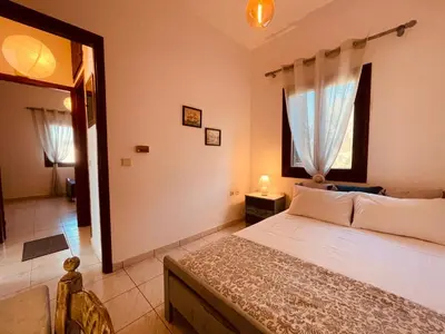 a bedroom with a large bed and a window at Brina's House in Kissamos
