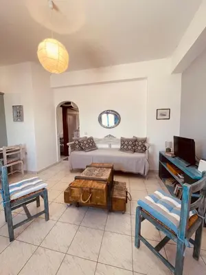 a living room with a bed and a table at Brina's House in Kissamos