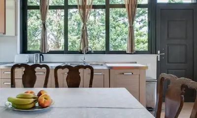a kitchen with a table with a plate of fruit on it at Villa Rotunda A in Kolymvari