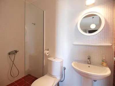 a bathroom with a toilet and a sink and a mirror at Villa Rotunda A in Kolymvari