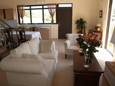 a living room with a white couch and a table at Villa Rotunda A in Kolymvari