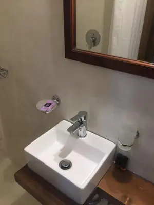 a white sink in a bathroom with a mirror at Captain Vasilis Hotel in Chania Town