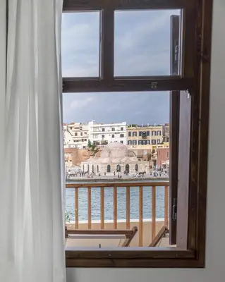 a window with a view of a body of water at Captain Vasilis Hotel in Chania Town