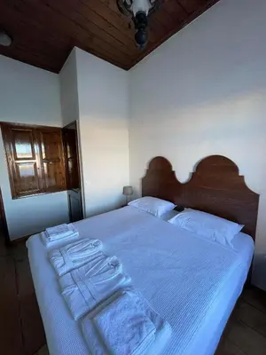 a bedroom with a bed with two towels on it at Captain Vasilis Hotel in Chania Town