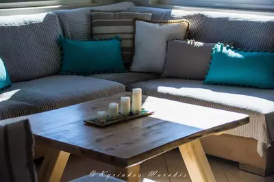 a living room with a couch and a table with candles at La Casa Del Vitsi in Palaiochóra