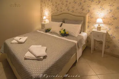 a bedroom with a large bed with towels on it at La Casa Del Vitsi in Palaiochóra