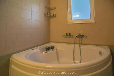 a bath tub in a bathroom with a window at La Casa Del Vitsi in Palaiochóra