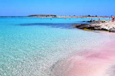 a beach with a bunch of people in the water at Mrs Chryssana Beach Hotel in Kolymvari