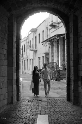 a man and a woman walking down an alley at Mrs Chryssana Beach Hotel in Kolymvari