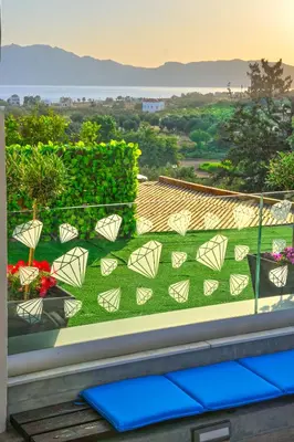 a balcony with a view of a yard with flowers at Villa Zafyra in Kissamos