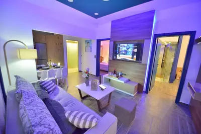 a living room with a purple couch and a table at Villa Zafyra in Kissamos