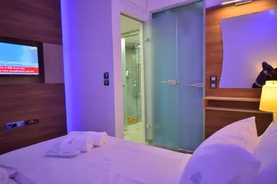 a bedroom with a bed with a mirror and a tv at Villa Zafyra in Kissamos