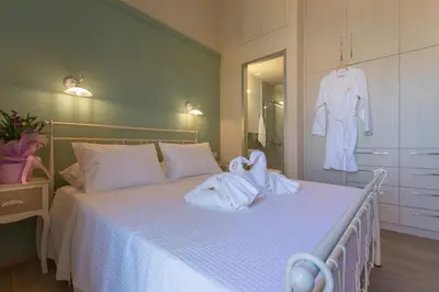 a bedroom with a bed with towels on it at Villa Theta With Private Pool by Amara Living in Drapaniás