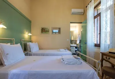 two beds in a room with green walls at Villa Theta With Private Pool by Amara Living in Drapaniás