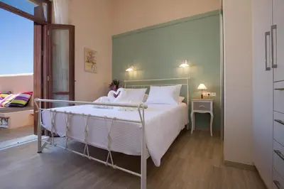 a bedroom with a large bed with white pillows at Villa Theta With Private Pool by Amara Living in Drapaniás