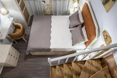 an attic room with a bed and a chair at Elvie House in Chania Town