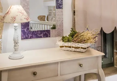 a table with a lamp and a basket on it at Elvie House in Chania Town