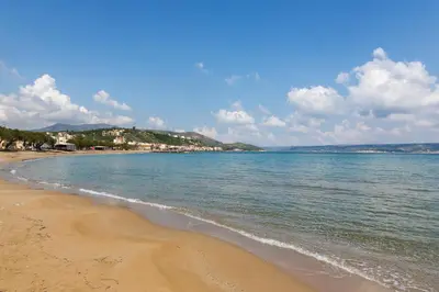 a view of a beach with the ocean and buildings at Porto Kalyves Seaside Aparthotel in Kalyves