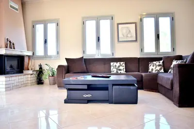 a living room with a couch and a coffee table at Almyrida sea view house in Almirida