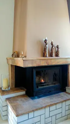 a fireplace with four figurines on top of it at Almyrida sea view house in Almirida