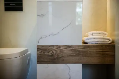 a bathroom with towels on a counter next to a toilet at Artemide city places- Petite Apartments in Chania Town