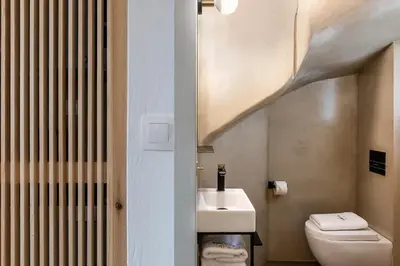 a bathroom with a white toilet and a sink at Artemide city places- Petite Apartments in Chania Town