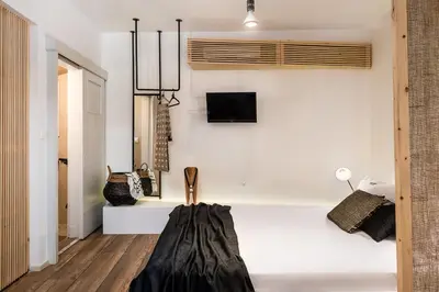 a bedroom with a bed and a tv on the wall at Artemide city places- Petite Apartments in Chania Town