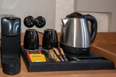 a tray with a tea pot and cups on a counter at Mosaic Venetian Harbour Suites in Chania Town