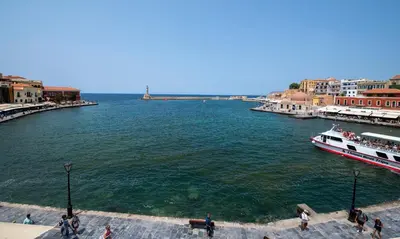 a river with a boat in the water at Mosaic Venetian Harbour Suites in Chania Town