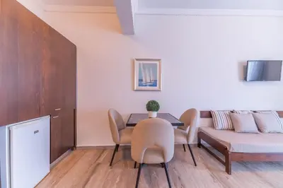 a living room with a table and a couch at Kalamaki Mare Suites in Kalamaki Chanion