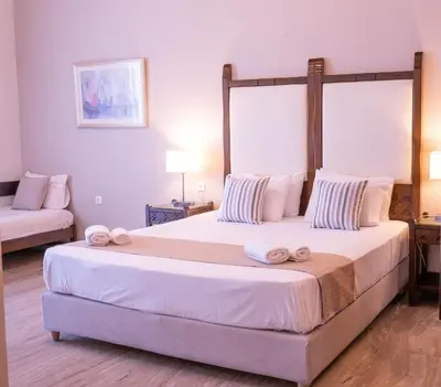 a bedroom with a large bed with towels on it at Kalamaki Mare Suites in Kalamaki Chanion