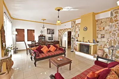 a living room with a couch and a fireplace at Villa Seli in Gerani Chanion