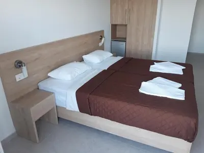 a bedroom with a large bed with towels on it at Calypso in Agia Roumeli