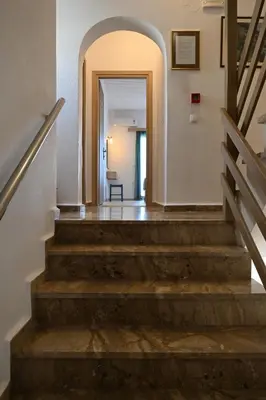 a hallway with stairs and an archway at Calypso in Agia Roumeli