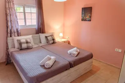 a bedroom with a bed with towels on it at Seashore Apartments in Chorafakia
