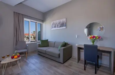 a living room with a couch and a table at Stoa Suites Chania in Chania Town