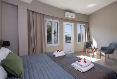 a bedroom with a bed with towels on it at Stoa Suites Chania in Chania Town