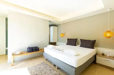 a bedroom with a large white bed in a room at Physis Villas Chania in Ayiá