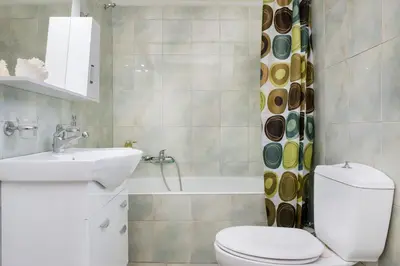 a bathroom with a toilet and a sink and a tub at Nina's House in Kamisianá