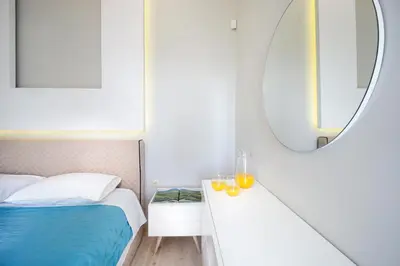a bedroom with a bed and a mirror at Rooftop Jacuzzi Apartment in Chania Town