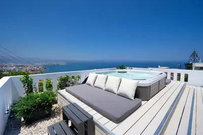 a patio with a hot tub on a deck at Rooftop Jacuzzi Apartment in Chania Town