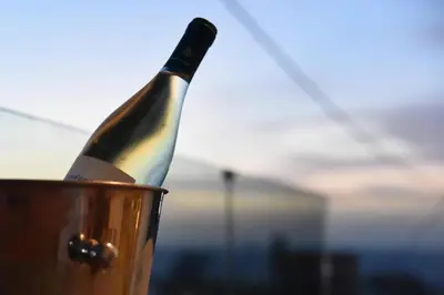 a bottle of wine is in a bucket at Rooftop Jacuzzi Apartment in Chania Town