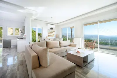 a living room with a couch and a table at Rooftop Jacuzzi Apartment in Chania Town