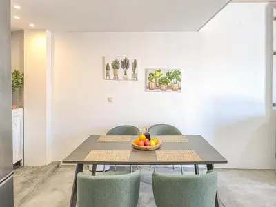 a dining room table with chairs and a bowl of fruit at Charming Old Tannery House with Spacious Veranda and Stunning Sea View! in Chania Town