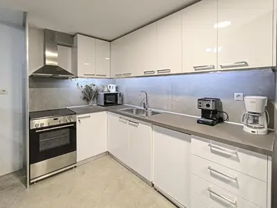 a kitchen with white cabinets and a sink at Charming Old Tannery House with Spacious Veranda and Stunning Sea View! in Chania Town